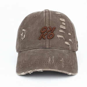 Close-up of distressed vintage wash baseball cap with OXKO embroidery and ripped details