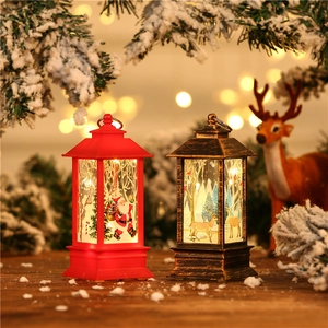 Close-up of LED Christmas lanterns with Santa and reindeer figures in warm glowing light