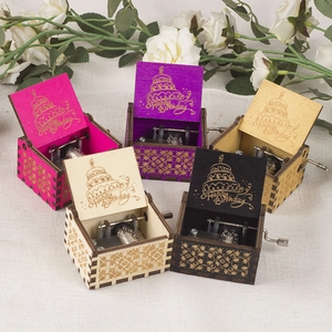 Handcrank wooden music box collection featuring birthday cake engraving and visible gears