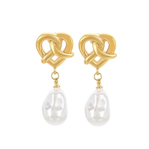 Vintage heart knot gold earrings with baroque pearl drops on a clean white background