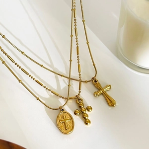 Three-piece set of vintage gold titanium steel necklaces with diverse cross pendants