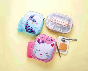 Close-up of insulated unicorn lunch bags with a three-compartment stainless steel bento box