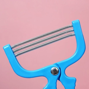 Manual facial hair remover with blue plastic handle and triple metal springs on pink background