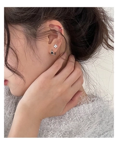 Silver star stud and black heart hoop earring set shown on model for daily wear