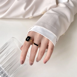 French style gold ring set with black enamel rectangle gem and small diamond accent