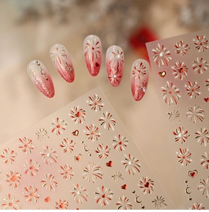 Detail of red and gold heart firework nail stickers with shimmering gradient nail art