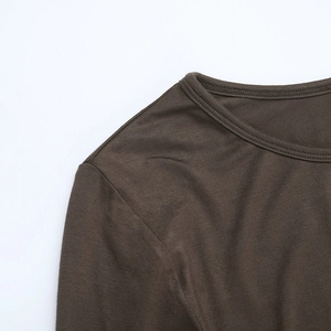 Close-up of olive brown long-sleeve dress with round neck and fine knit texture