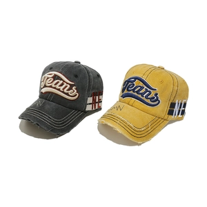 Close-up of distressed brim detail and Jeans embroidery on vintage washed cotton caps