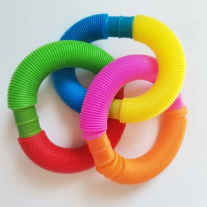 Close-up of colorful plastic pop tubes linked in a ring showing telescopic texture