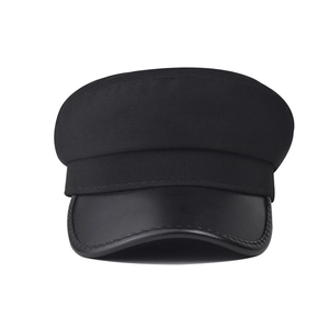 Classic black newsboy hat featuring textured fabric body and sleek faux leather brim