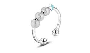 Detailed view of silver fidget ring with three sliding frosted beads for stress relief
