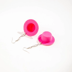 Detail shot of pink felt top hat earrings with silver hooks and festive textured design