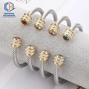 Macro view of two-tone stainless steel cable bracelets with inlaid stones and diamonds