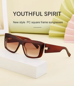 Square cat-eye sunglasses with brown tortoiseshell frame on artistic geometric props