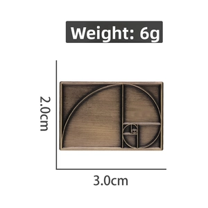 Detailed macro view of golden ratio Fibonacci spiral engraved on a copper rectangle pin