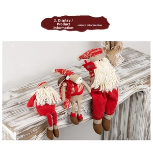 Detailed view of plush Christmas dolls with Bienvenue sign on a white fireplace