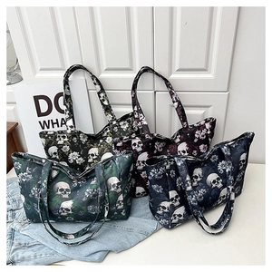 Detail view of large tote bags featuring gothic skull and floral prints in four colors