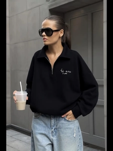 Minimalist black quarter-zip sweatshirt with chest embroidery and drop shoulder design