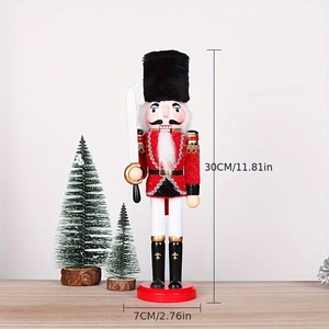 Close-up of 30cm wooden nutcracker soldier in red uniform with silver sword detail