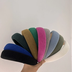 Multiple colors of padded textured fabric headbands held in a stylish fan display