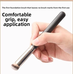 Detail of angled foundation brush with soft dual-tone bristles and black handle