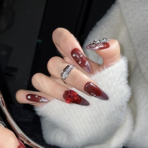 Dark red almond press-on nails with 3D heart diamond and silver bow metallic accents
