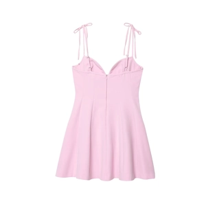Back view of pink mini dress showing invisible zipper and adjustable bow shoulder ties