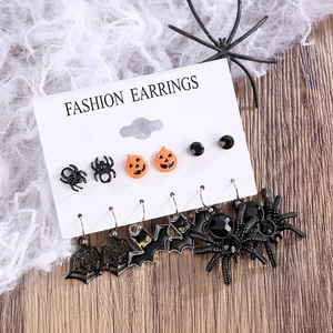 Detailed set of Halloween stud earrings with pumpkin, spider, and bat charms on display