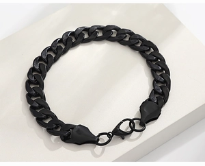 Detailed view of black curb link bracelet with classic metallic luster and lobster clasp