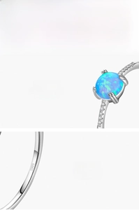 Detail of S925 sterling silver ring with blue-green opal and pave-set diamonds
