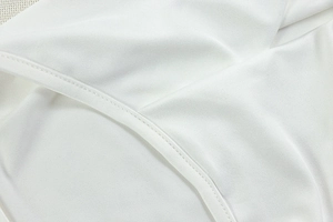Macro detail of high-elasticity white knit fabric with precision stitching and soft texture