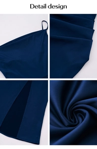 Détails d'une robe de soirée bleu foncé montrant fines bretelles, plis et fente latérale