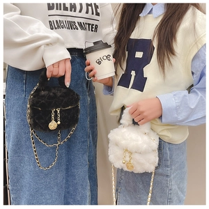 Close-up of plush quilted mini chain bags in black and beige with gold rose pendants
