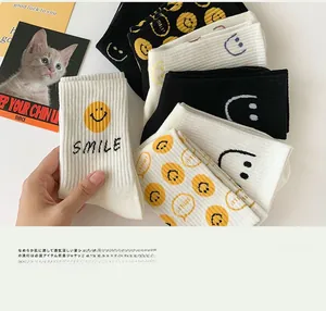 Close-up of smile printed cotton socks with ribbed texture in black and white colors