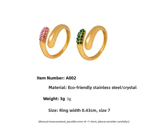 Detailed close-up of gold stainless steel open rings with pink and green zircon stones