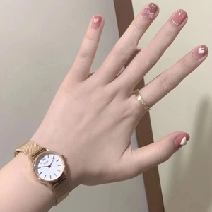 Pink press-on nails with 3D hearts paired with rose gold mesh watch and ring