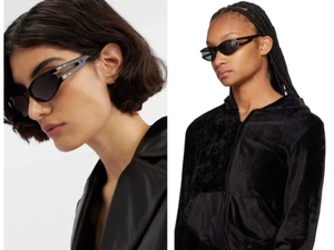 Detail of black oval sunglasses featuring a unique hollow temple design on model