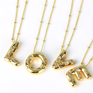 Hip hop gold letter pendant necklace with sparkling zircons on white background