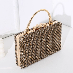 Luxurious gold evening clutch bag with sparkling rhinestone texture and metal top handle