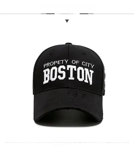 Detail of Boston embroidery on black cotton baseball cap with distressed brim