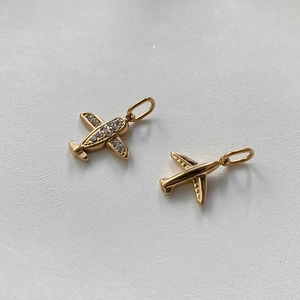 Golden airplane pendants with sparkling zircon stones and polished finish for women