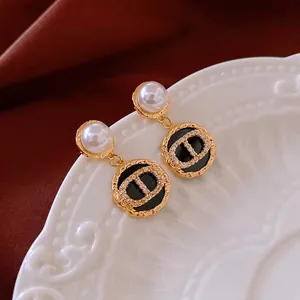 French vintage earrings with pearl, black enamel pendant and sparkling zircon details