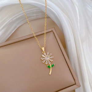Detailed macro view of a gold daisy pendant with white and green crystal petals