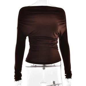 Detailed close-up of dark brown off-shoulder top with ruched texture and fitted sleeves