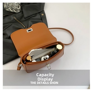 Detail showing internal capacity of the caramel brown bag with phone and cosmetics