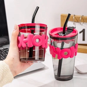 Minimalist grey glass tumbler set with pink silicone sleeves and black straws in 2 sizes