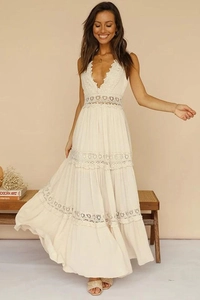 Close-up detail of the deep V-neckline and intricate floral lace embroidery on the cream dress