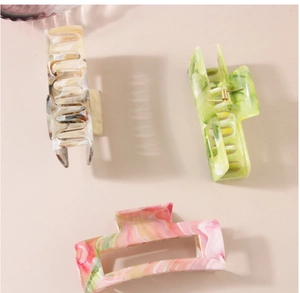 Detailed set of three marble texture rectangular hair claws with golden metal springs