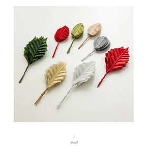Close-up of colorful artificial Christmas leaves with wire stems for DIY craft decoration