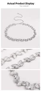 Detailed macro view of silver butterfly metal waist chain with adjustable lobster clasp
